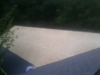 New OSB roof sheathing installed beside an existing shingle roof in Steep Falls