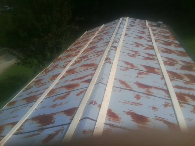 Rusted metal roof panels with new wood purlins before replacement — Storm Damage Roof Repair in Steep Falls by Roofing Brothers